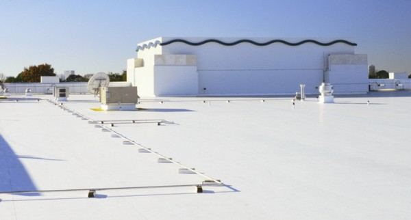 Completed white TPO roof with coping and rooftop equipment